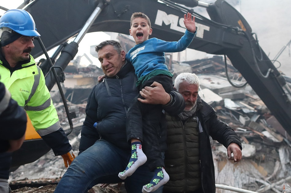 Eight-year-old Yigit Cakmak reacts after being rescued from the site of a collapsed building, some 52 hours after a major earthquake, in Hatay, Turkey on Feb. 8, 2023. Erdem, Sahin, EPA-EFE