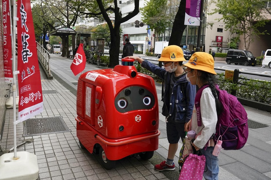 DeliRo, a delivery robot developed by Japanese robotics technology company ZMP, delivers postal items between a post office and a hospital in Tokyo, Japan, Nov. 6, 2020. The delivery robot has been developed along with single seater robot RakuRo and unmanned patrol robot PATORO. The robots have been aiding people in everyday life tasks amid the ongoing COVID-19 pandemic. Kimimasa Mayama, EPA-EFE/File 