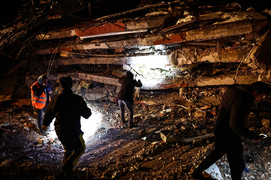 Emergency personnel search for victims at the site of a collapsed building in the aftermath of a powerful earthquake in the Elbistan district of Kahramanmaras, southeastern Turkey, 07 February 2023. Thousands of people died and thousands more were injured after major earthquakes struck southern Turkey and northern Syria on 06 February. Authorities fear the death toll will keep climbing as rescuers look for survivors across the region. EPA-EFE/SEDAT SUNA