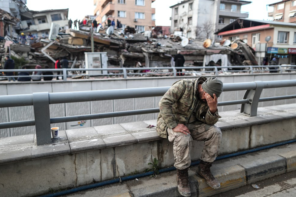 A Turkish soldier reacts in front of a collapsed building in Antakya, district of Hatay, Turkey, February 7, 2023. Erdem Sahin, EPA-EFE/File