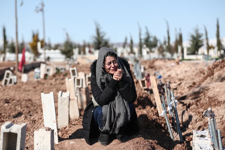 A woman mourns her relatives at a mass grave area following a major earthquake in Adiyaman, southeastern Turkey, 11 February 2023. More than 28,000 people have died and thousands more are injured after two major earthquakes struck southern Turkey and northern Syria on February 6. Authorities fear the death toll will keep climbing as rescuers look for survivors across the region. Sedat Suna, EPA-EFE