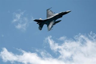 Japan's ruling bloc OKs easing weapon use against flying objects