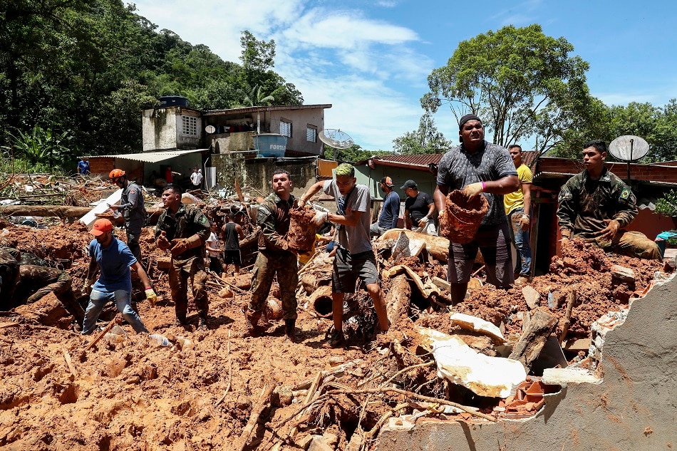 Members of Brazilian army, firefighters and Civil Protection work to rescue victims after a landslide due to heavy rains in Sao Sebastiao, Sao Paulo state, Brazil, 21 February 2023. At least 44 people died due to heavy rains in Sao Paulo region, according to official figures. EPA-EFE/Sebastiao Moreira
