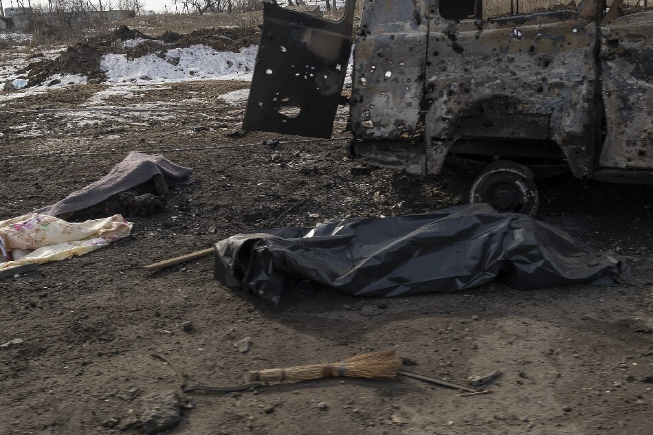 Covered bodies of two locals killed in shelling lie on a road in Bakhmut, Ukraine, 24 February 2023. Russian troops entered Ukrainian territory on 24 February 2022, starting a conflict that has provoked destruction and a humanitarian crisis. One year on, fighting continues in many parts of the country. EPA-EFE/GEORGE IVANCHENKO
