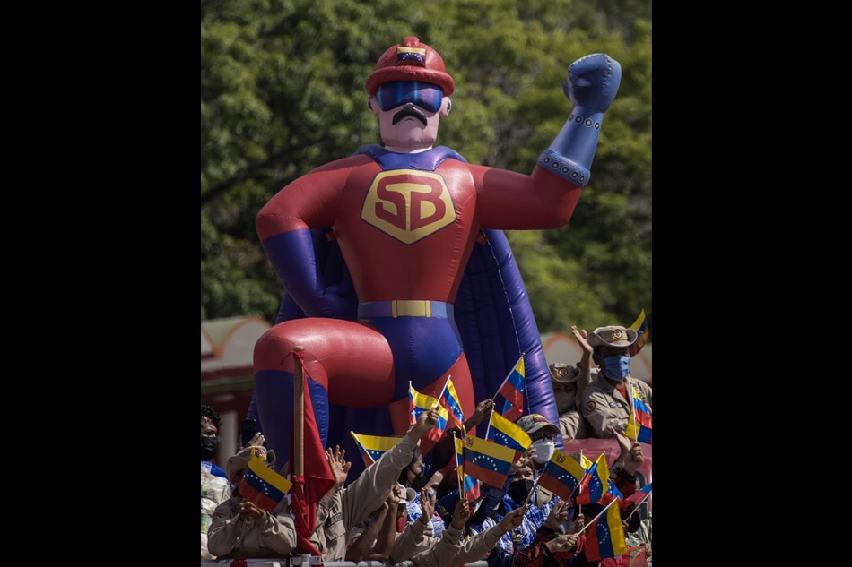 An inflatable that represents the animated character 'Super Bigote', a cartoon superhero based on the image of the president of Venezuela, Nicolas Maduro, during the civic-military parade to commemorate the 211th anniversary of the signing of the Act of Independence of Venezuela, on the Paseo Los Proceres in Caracas, Venezuela, 05 July 2022. 12,023 military, police and civilian officials participated in the parade, according to the state channel Venezolana de Television (VTV) during the broadcast. EPA-EFE/Miguel Gutierrez