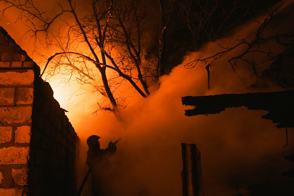 A rescuer tries to put out a fire of a private building after a Russian shelling in the Ivanivka village near Bakhmut of the Donetsk area, Ukraine, 02 January 2023. George Ivanchenko, EPA-EFE.