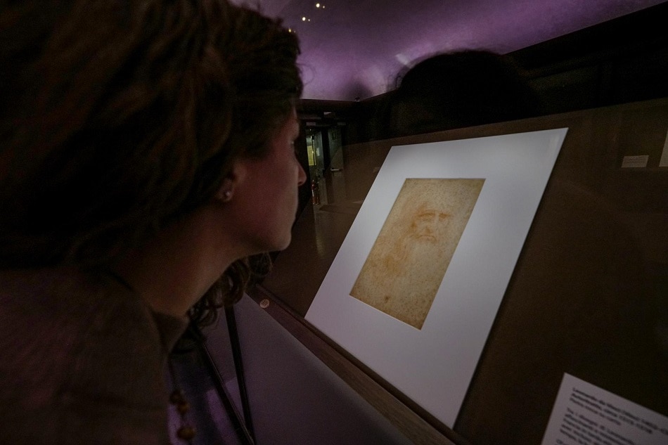 A visitor observes the self-portrait of Leonardo 1515-1518 displayed in the exhibition 'The time of Leonardo 1452-1519' on the occasion of the celebrations of the five hundredth anniversary of the death of Leonardo da Vinci, at the Royal Museums, Biblioteca Reale, Turin, 10 December 2019. EPA-EFE/TINO ROMANO