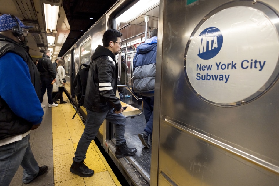 People enter a New York City subway car in New York, New York, USA, April 21, 2022. Justin Lane, EPA-EFE 