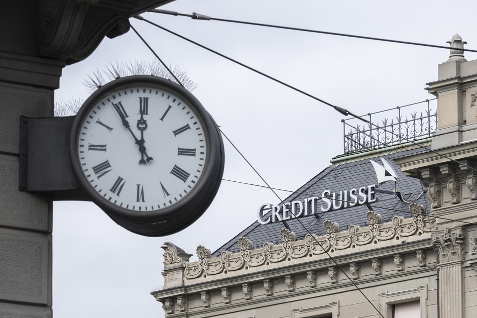 Five to twelve is written on a clock next to a logo of the Swiss bank Credit Suisse, in Zurich, Switzerland, March 20, 2023. Financial markets are reacting after troubled bank Credit Suisse was rescued in a three billion dollars purchase by its Swiss rival UBS in a government-backed deal. UBS is down 13 percent and other European bank shares have also dropped significantly. Ennio Leanza, EPA-EFE.