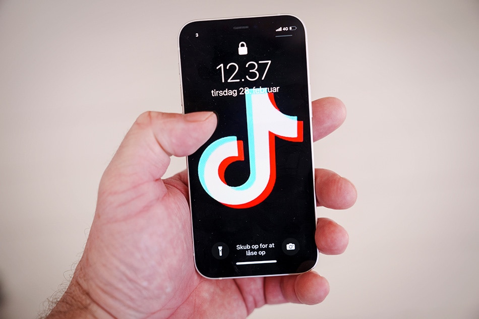 TikTok application logo displayed on a mobile phone in Randers, Denmark, 28 February 2023. The Danish Parliament announced on 28 February that it had asked MPs and all of its staff to delete the TikTok application from their work phones because of the 'risk of espionage'. EPA-EFE/Bo Amstrup DENMARK OUT