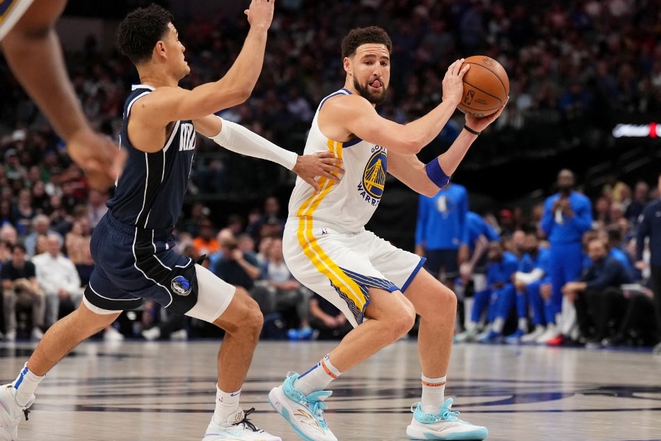 Klay Thompson (11) of the Golden State Warriors handles the ball against the Dallas Mavericks at the American Airlines Center in Dallas, Texas. Cooper Neill, NBAE via Getty Images/AFP