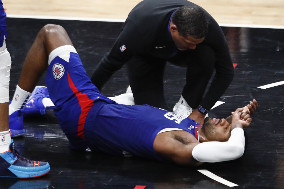 LA Clippers forward Paul George lies on the ground after appearing to injure his knee during the fourth quarter of the NBA basketball game between the Los Angeles Clippers and the Oklahoma City Thunder at Crypto.com Arena in Los Angeles, California, USA, 21 March 2023. EPA-EFE/CAROLINE BREHMAN