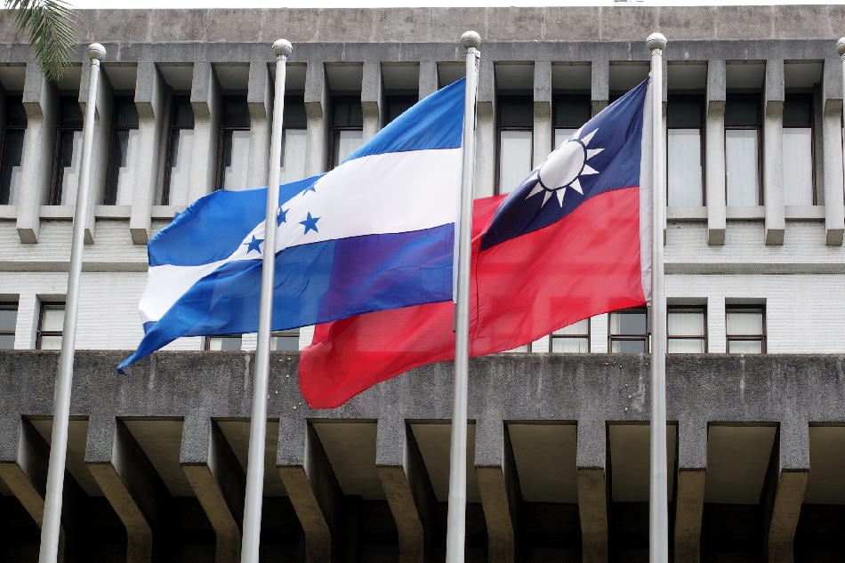 The national flags of Honduras (L) and Taiwan (R) fly side by side in front of the Foreign Ministry in Taipei, Taiwan, July 2, 2017. More than five years later, Honduras cut its diplomatic ties with Taiwan after earlier saying it would establish relations with China. David Chang, EPA/file