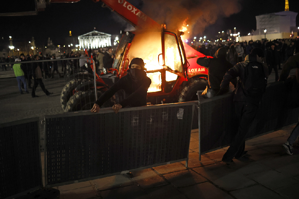 Protesters set construction equipment on fire on Place de la Concorde square, facing the French Parliament (National Assembly) in Paris, France, March 16, 2023, after the French government pushed a pensions reform through parliament without a vote. Yoan Valat, EPA-EFE
