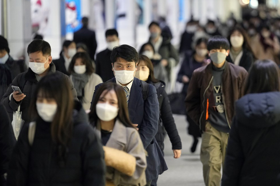 Commuters walk through a corridor at Shinjuku business district in Tokyo, Japan, on January 16, 2023. Franck Robichon, EPA-EFE/file