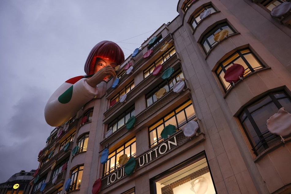 A sculpture of Japanese artist Yayoi Kusama is on display on the rooftop of the Louis Vuitton store on the Champs Elysees in Paris, France, Feb. 2, 2023. The action celebrates Louis Vuitton's second collaboration with artist Yayoi Kusama. Yoan Valat, EPA-EPE 