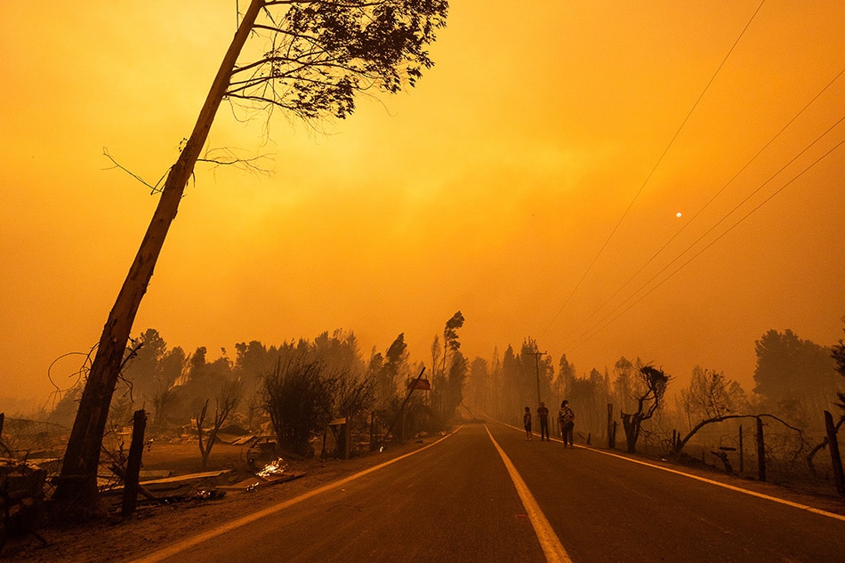 A view on a yellow sky and smoke during a wild fire near the city of Santa Juana, Chile, Feb. 3, 2023. Pablo Hidalgo, EPA-EFE/file
