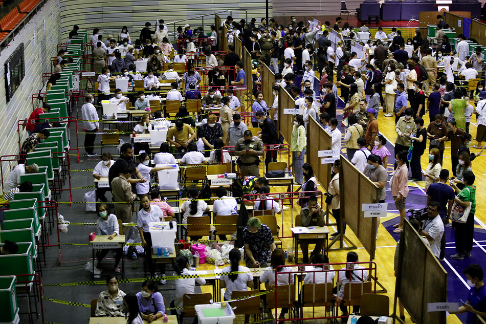 Thai voters line up to cast ballots during the general election advance voting at a designated polling station in Bangkok, Thailand, 07 May 2023. Rungroj Yongrit, EPA-EFE.