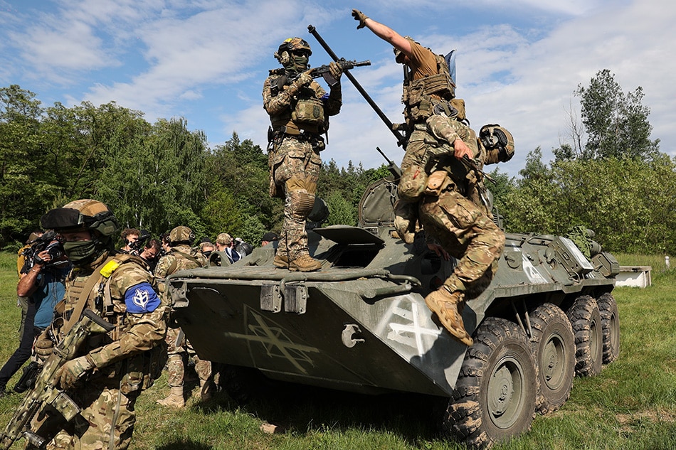 Members of the 'Russian Volunteer Corps' and 'Freedom of Russia Legion' with an armored vehicle during a meeting with the media not far from the Ukraine-Russia border in Kharkiv's area, northeastern Ukraine, May 24, 2023, amid the Russian invasion. According to the group of Russian fighters, who are aligned with Ukraine, during a meeting with the press on May 24, they engaged in cross-border raids on the territory of the Belgorod region of Russia starting on May 22, 2023. Ukraine has denied Russia's allegation that it was behind the attacks on the Belgorod region and portrayed the incursions by the Russian volunteers as an uprising against the Kremlin and Putin's regime. Russian troops entered Ukraine on Feb. 24, 2022 starting a conflict that has provoked destruction and a humanitarian crisis. Sergey Kozlov, EPA-EFE 