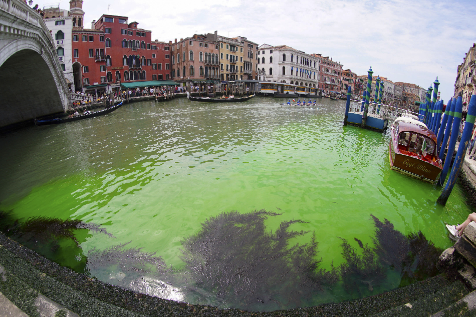 A picture taken with a fisheye lens shows a patch of phosphorescent green liquid seen on the Grand Canal near the Rialto Bridge, in Venice, Italy, 28 May 2023. On the morning of 28 May a patch of phosphorescent green liquid appeared in the waters of Venice, along the Grand Canal near the Rialto Bridge. Firefighters took water samples, while an urgent meeting between the police forces of the city was convened by the Prefect of Venice, as the cause is still unknown. EPA-EFE/ANDREA MEROLA
