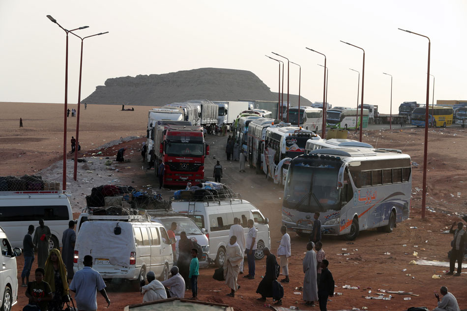 Sudanese people wait for transportation after crossing the border from Sudan, Abu Simbel, southern Egypt, 18 May 2023. Khaled Elfiqi, EPA-EFE