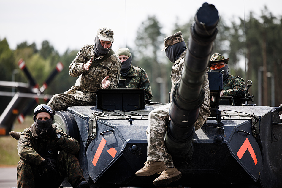  Ukrainian soldiers sit on top of a tank during a visit of the German and Danish Defense Ministers at the Federal Armed Forces (Bundeswehr) training hub in Klietz, Germany, May 5, 2023. Clemens Bilan, EPA-EFE/File
