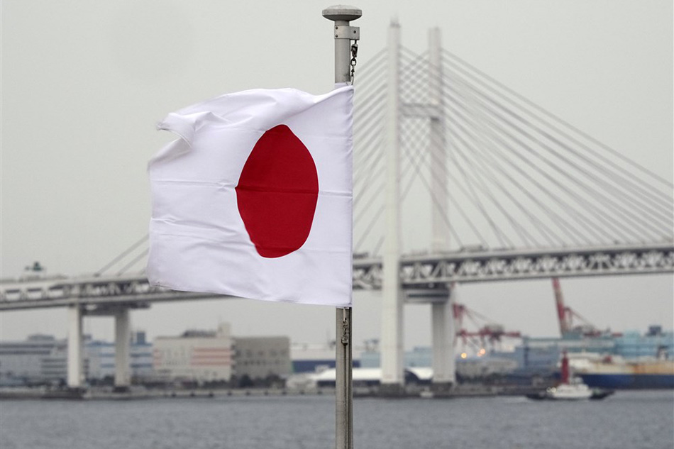 A Japanese national flag waves at a port in Yokohama, near Tokyo, Japan on Jan. 19, 2023. Franck Robichon, EPA-EFE/File