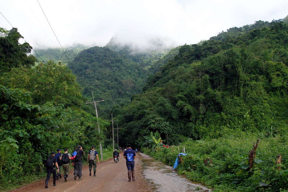 Thai people and officials travel along a road toward the Tham Luang cave in Tham Luang Khun Nam Nang Noon Forest Park in Chiang Rai province, Thailand, July 1, 2018. Pongmanat Tasiri, EPA-EFE/File.