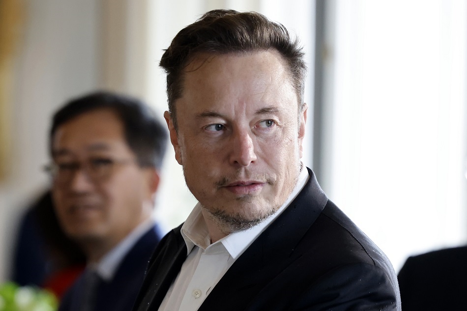 SpaceX, Twitter and electric car maker Tesla CEO Elon Musk (R) looks on among other CEOs before a roundtable during the 6th edition of the 