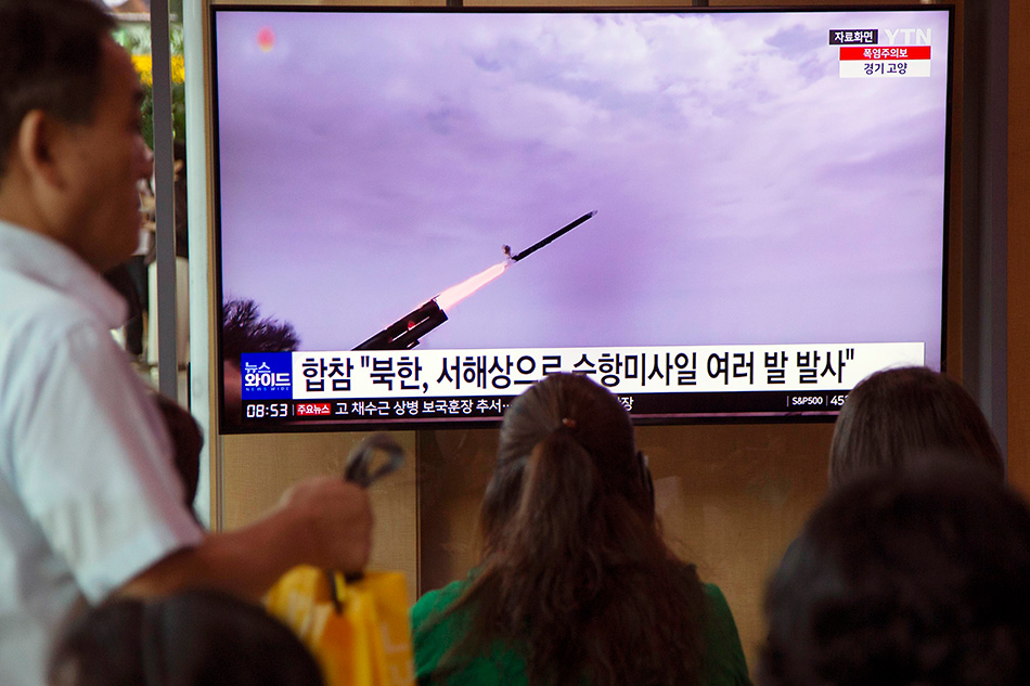 People watch a news report on a North Korean cruise missile launch at a station in Seoul, South Korea, 22 July 2023. According to South Korea