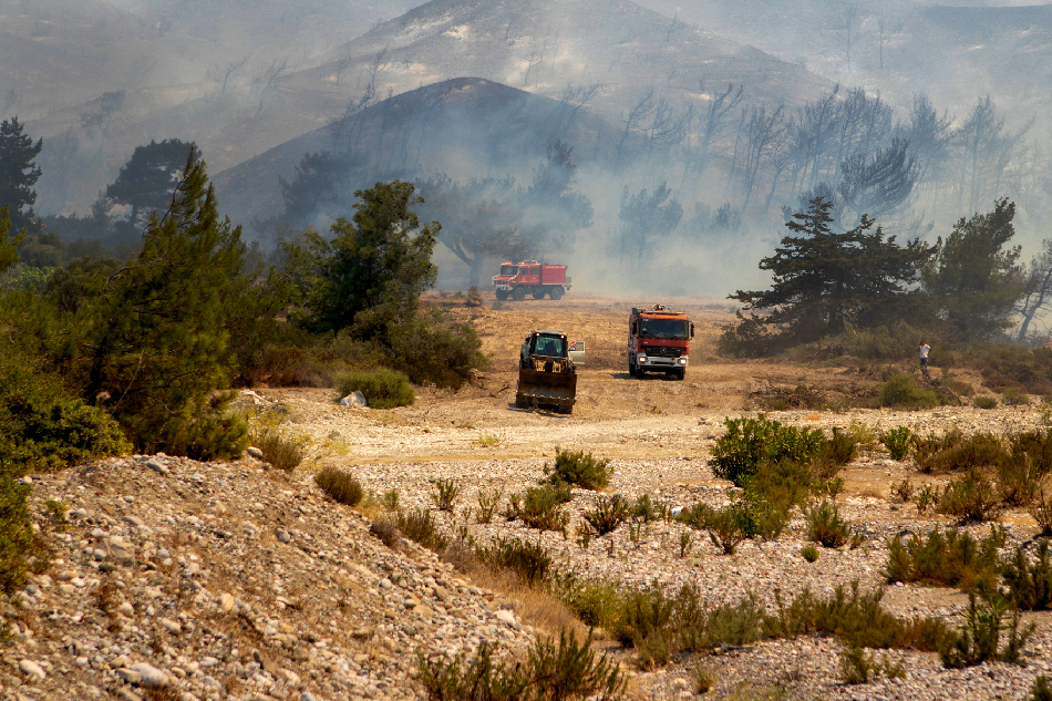 Τractors operate during a wildfire in Vati village, on Rhodes island, Greece, July 25, 2023. Damianidis Lefteris, EPA-EFE
