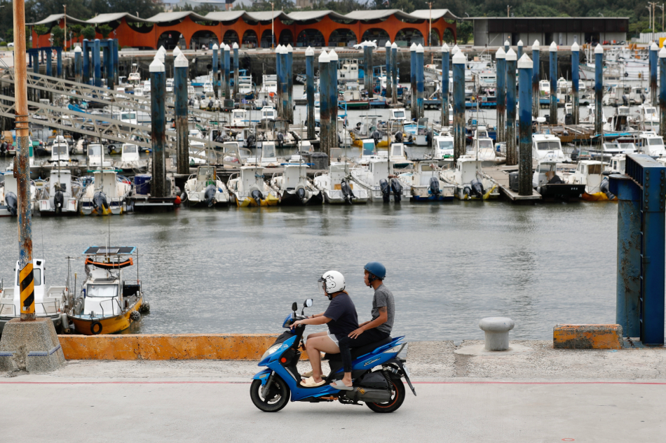 Taiwanese residents drive next to fishing boats anchored as a precaution against Typhoon Haikui, at Nanliao Fishing Harbor in Hsinchu, Taiwan, September 3, 2023. Typhoon Haikui moves closer to Taiwan, prompting local governments to close some offices and other establishments in southern and eastern Taiwan. Ritchie B. Tongo, EPA-EFE.