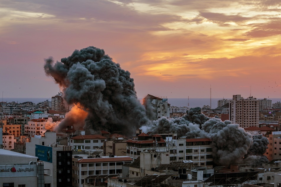 Smoke rises after Israeli warplanes targeted the Palestine tower in Gaza City, October 7, 2023. Mohammed Saber, EPA-EFE.