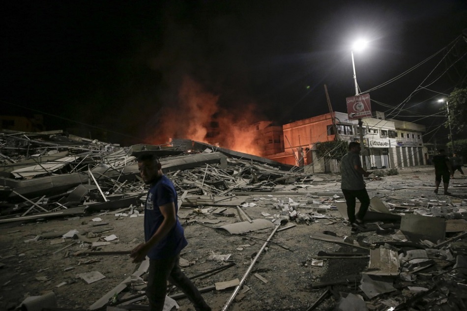Palestinians look at the aftermath of an Israeli air strike on Gaza City, on October 9, 2023. Haitham Imad, EPA-EFE