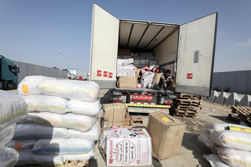 Egyptian volunteers handle humanitarian aid bound for Palestinians in the Gaza Strip, at the Rafah border crossing, Egypt, October 24, 2023. More than 5,000 Palestinians and over 1,400 Israelis have been killed, according to the Israel Defense Forces (IDF) and the Palestinian health authority, since Hamas militants launched an attack against Israel from the Gaza Strip on October 7. Khaled Elfiqi, EPA-EFE.