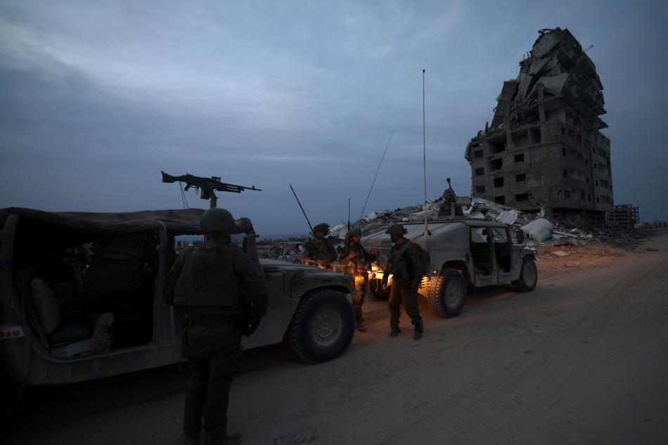 A photo taken while embedded with the Israel Defense Forces (IDF) shows Israeli soldiers with military vehicles at a position in the Palestinian town of Beit Lahia, on the outskirts of the city of Gaza, northern Gaza Strip, December 8, 2023. Israeli forces resumed military strikes on Gaza after a week-long truce expired on December 1. Atef Safadi, EPA-EFE.