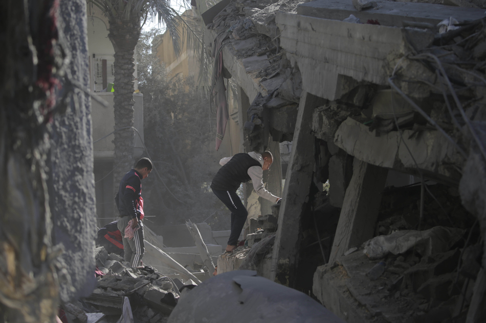 Palestinians search for victims and survivors among the rubble of the destroyed house of the Al Madfaa and Shabit families following Israeli airstrikes on Al Maghazi refugee camp, southern Gaza Strip, Dec. 11, 2023. Mohammed Saber, EPA-EFE/file 
