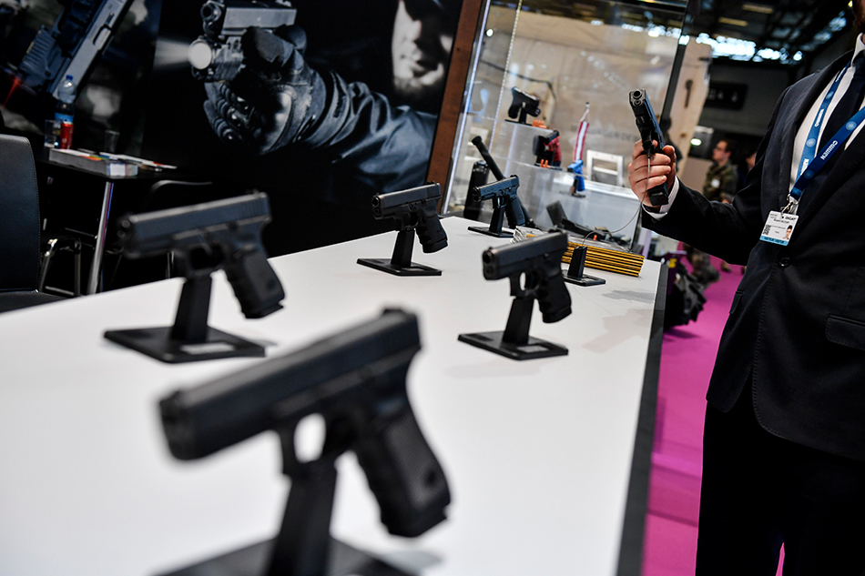 A visitor tries a gun made by Austria manufacturer Glock, on the opening day of the Eurosatory international Land and Air-Land Defense and Security fair in Villepinte, north of Paris, France, June 11, 2018. Julien Rosa, EPA-EFE 