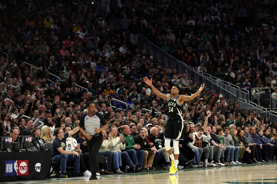 Giannis Antetokounmpo #34 of the Milwaukee Bucks reacts to a three point shot during the second half of a game against the Golden State Warriors at Fiserv Forum on December 13, 2022 in Milwaukee, Wisconsin. Stacy Revere, Getty Images/AFP