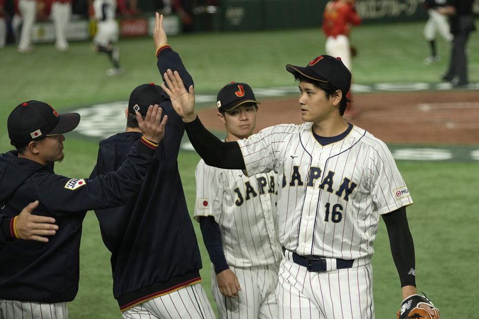Japan's starter Shohei Ohtani (R) is celebrated by his teammates after completing his pitches during the 2023 World Baseball Classic Tokyo pool game against China at Tokyo Dome in Tokyo, Japan, 09 March 2023. The final will be held in Miami, the United States, 21 March 2023. Kimimasa Mayama, EPA-EFE.