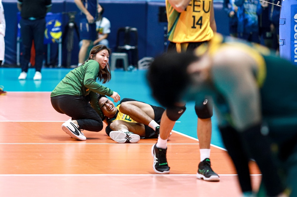 FEU's CJ Cabatac in pain after an injury against NU. UAAP Media.