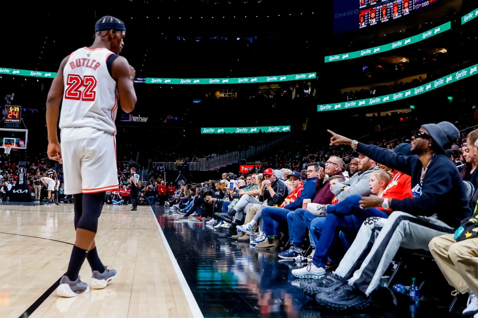 Miami Heat forward Jimmy Butler (L) listens to US rapper '2 Chainz' (R) during the second half of their NBA game against the Atlanta Hawks at State Farm Arena in Atlanta, Georgia, USA, January 16, 2023. Erik S. Lesser, EPA-EFE/File.