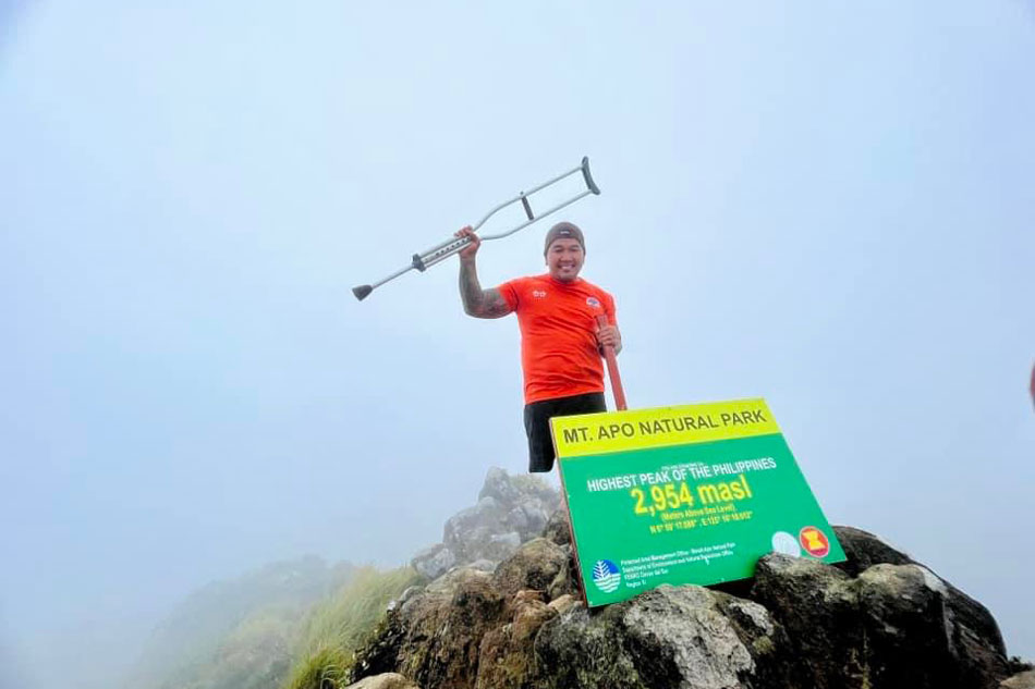 Para-athlete Arnold Balais celebrates after reaching the peak of Mount Apo, the highest mountain in the Philippines, for the second time. Photo courtesy of Climb for Everlasting Hope.