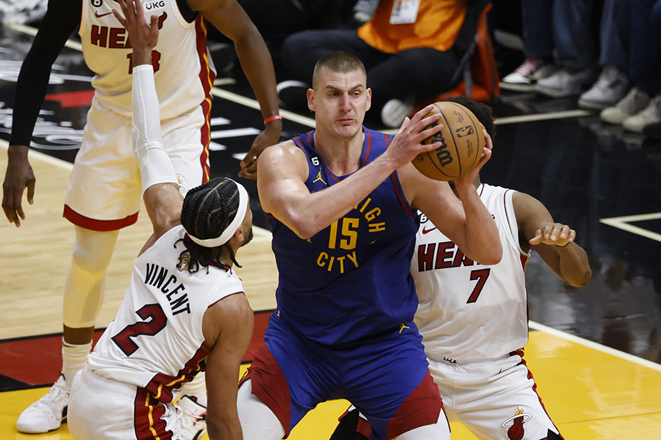 Denver Nuggets center Nikola Jokic (C) looks to pass as Miami Heat guard Gabe Vincent (L) and Miami Heat guard Kyle Lowry (R) defend during the second half of game three of the NBA Finals between the Denver Nuggets and Miami Heat at Kaseya Center in Miami, Florida, USA, 07 June 2023. EPA-EFE/RHONA WISE
