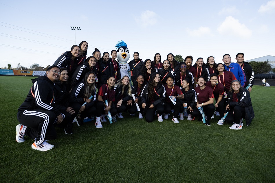 Members of the Philippines team pose for a group photo with the Tazuni, the mascot of the FIFA Women