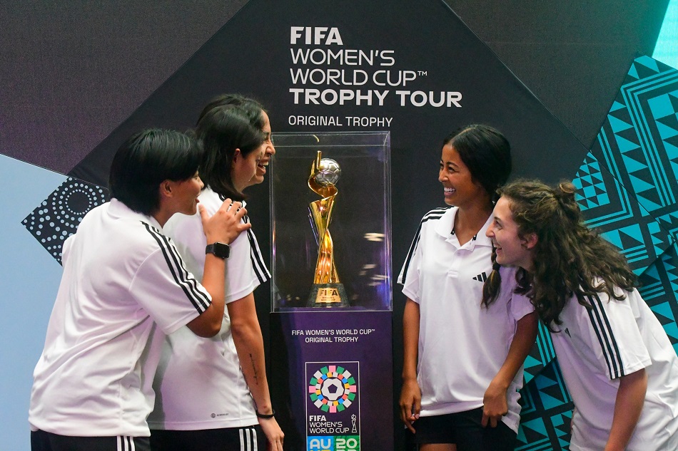 Members of the Philippine Women’s Football team take photos of themselves with the FIFA Women