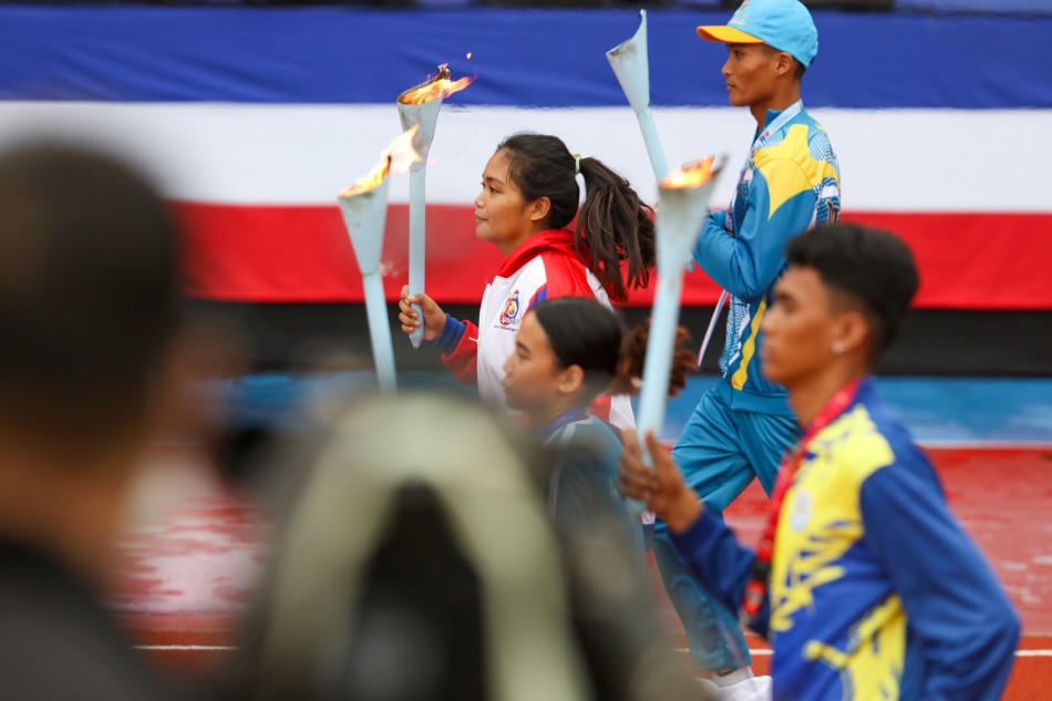 Athletes carry the torch for the lighting of the cauldron at the opening of the Palarong Pambansa at the Marikina Sports Park in Marikina City on July 31, 2023. Jonathan Cellona, ABS-CBN News