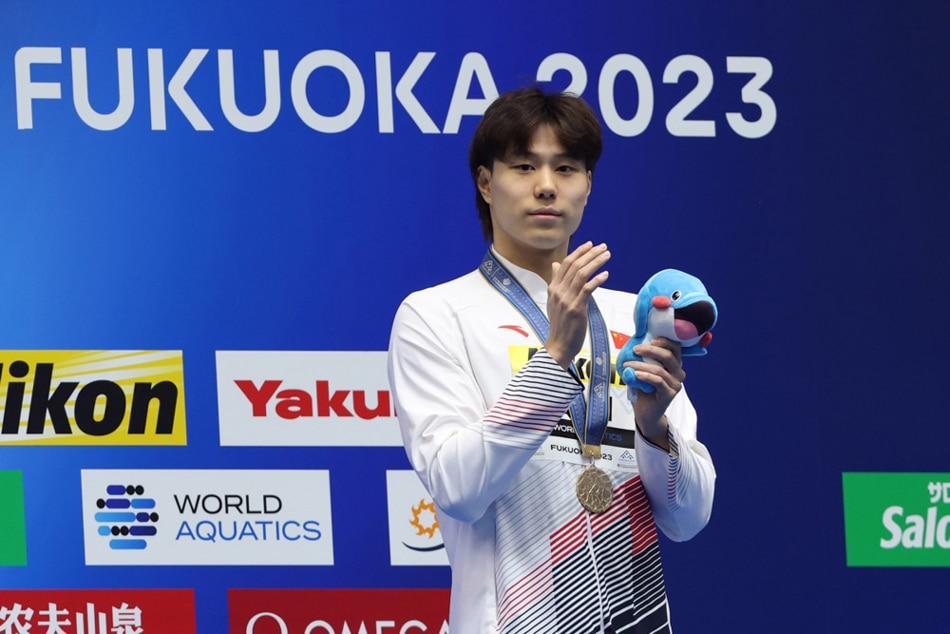 Gold medalist Haiyang Qin of China celebrates during the medal ceremony of the World Aquatics Championships 2023 in Fukuoka, Japan. Kiyoshi Ota, EPA-EFE