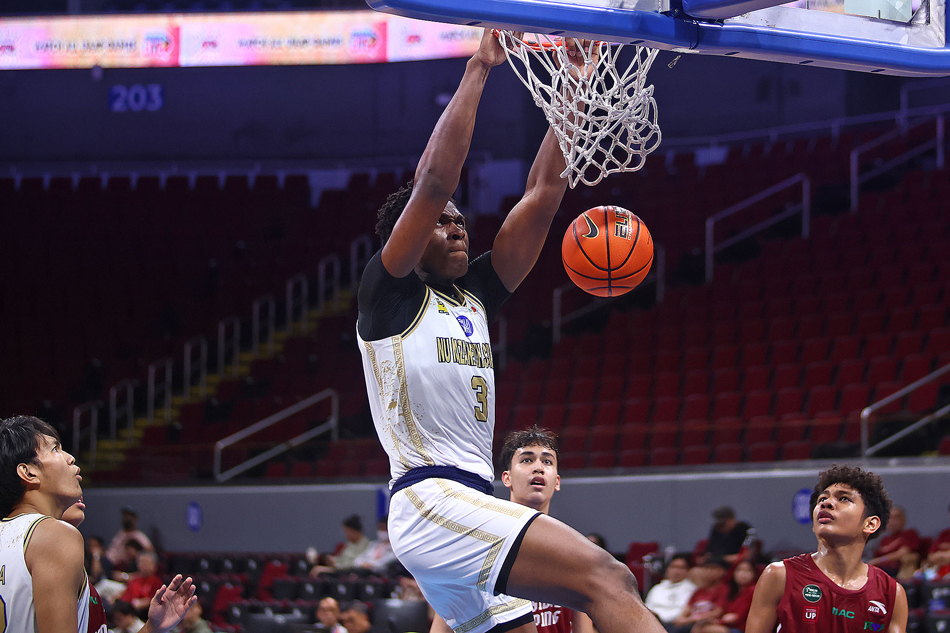 Nigerian center Collins Akowe of NU-Nazareth School dunks against UPIS in the UAAP Season 86 boys
