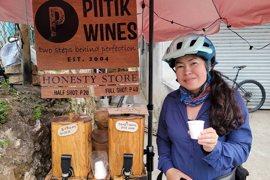 A tourist in Sagada, Mountain Province tries Piitik Wines at its honesty-system kiosk on the side of the road. Art Fuentes, ABS-CBN News